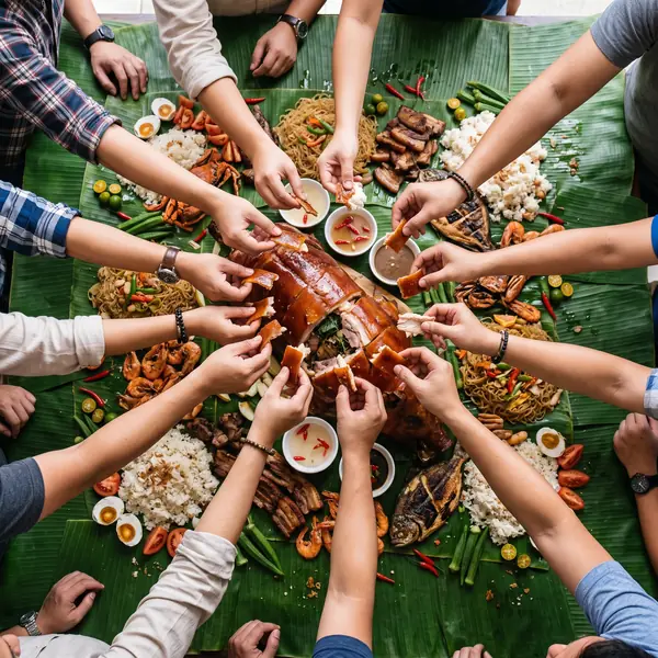 Adult hands toasting over food